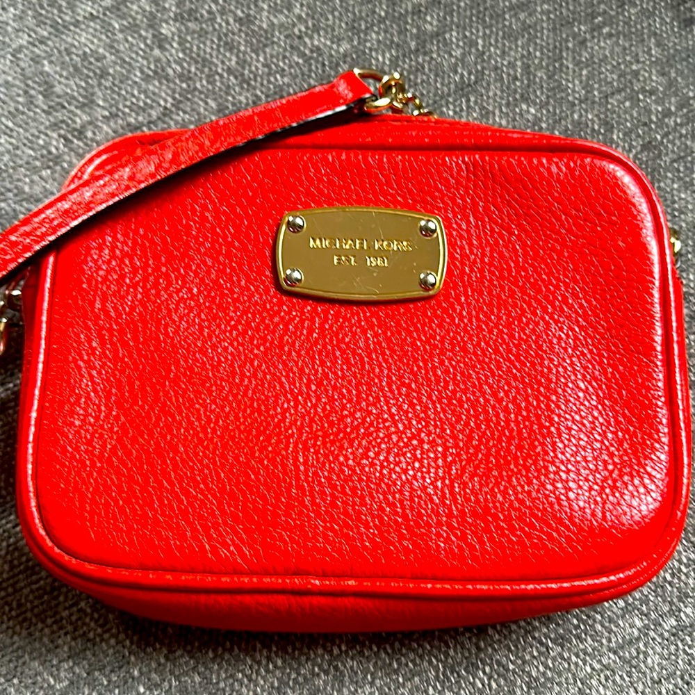 Orange MK cross body purse.
